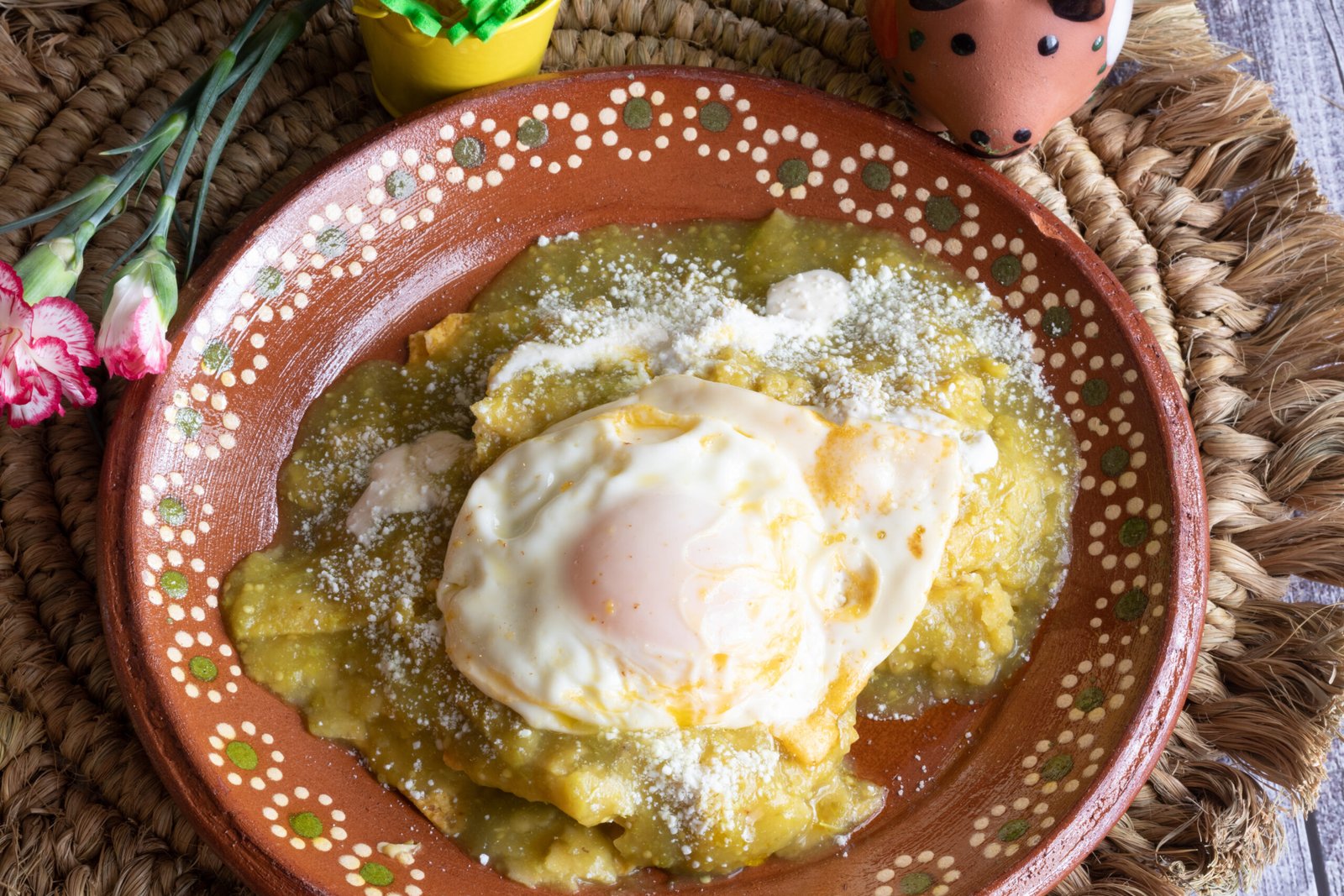 Mexican dish Green chilaquiles made with green tomatoes, jalapeno, sour cream and cheese