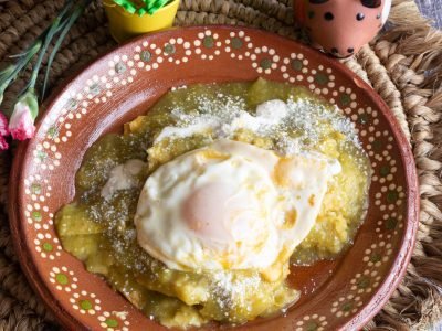 Mexican dish Green chilaquiles made with green tomatoes, jalapeno, sour cream and cheese